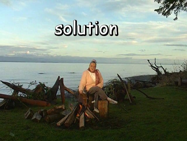 the word "solution" with Marie by a campfire on by the water