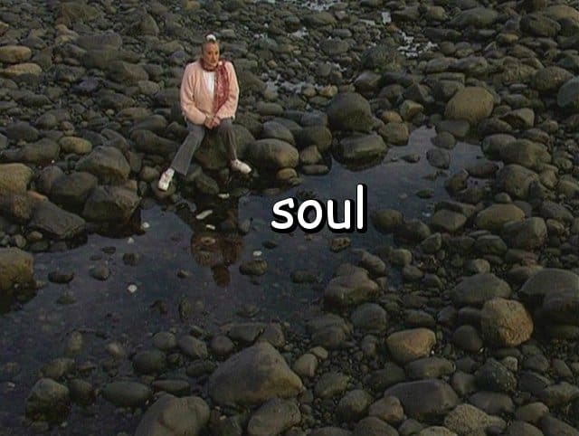 the word "soul" with Marie by a tide pool seen from above