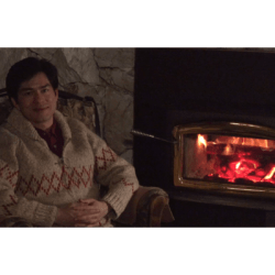 Thomas sitting before the fire, with the words "a very short sentence, just a main subject and main predicate, can be very effective"