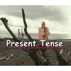 Marie in a driftwood tree, with the test "Present Tense"