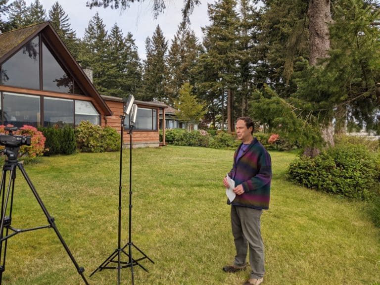 Cozy Grammar's Producer and Director David Mielke in front of Marie's Cozy Beach Cottage, filming the introduction to the updated and expanded Intermediate Cozy Grammar Course, Level 1.
